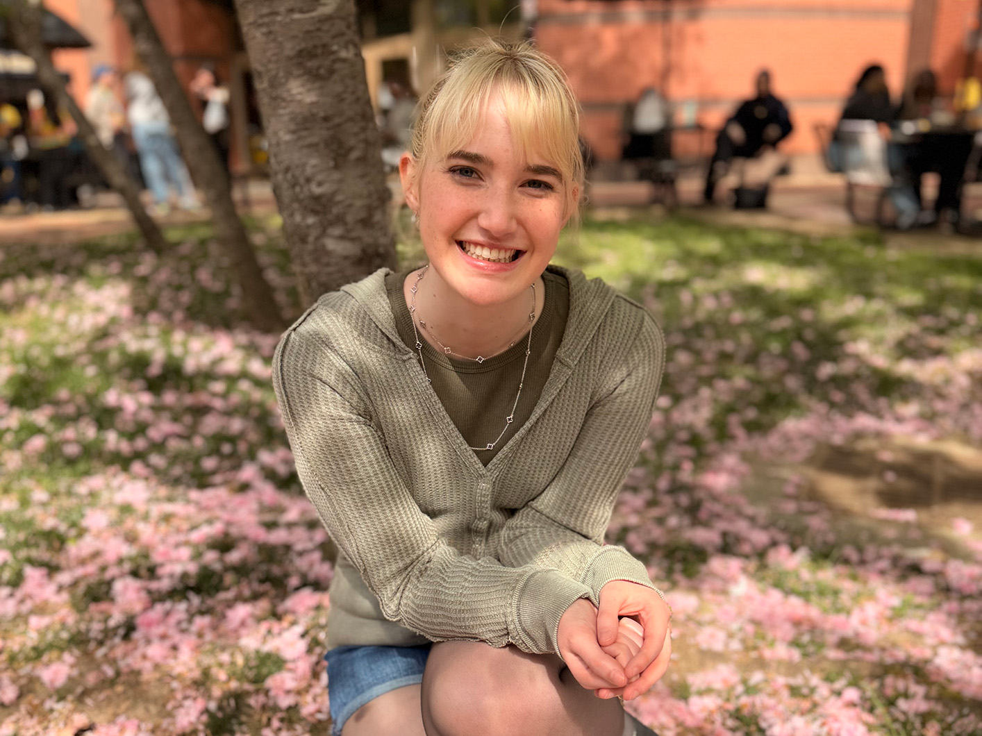 Blakely Wright sits in the grass outside of Shafer Court